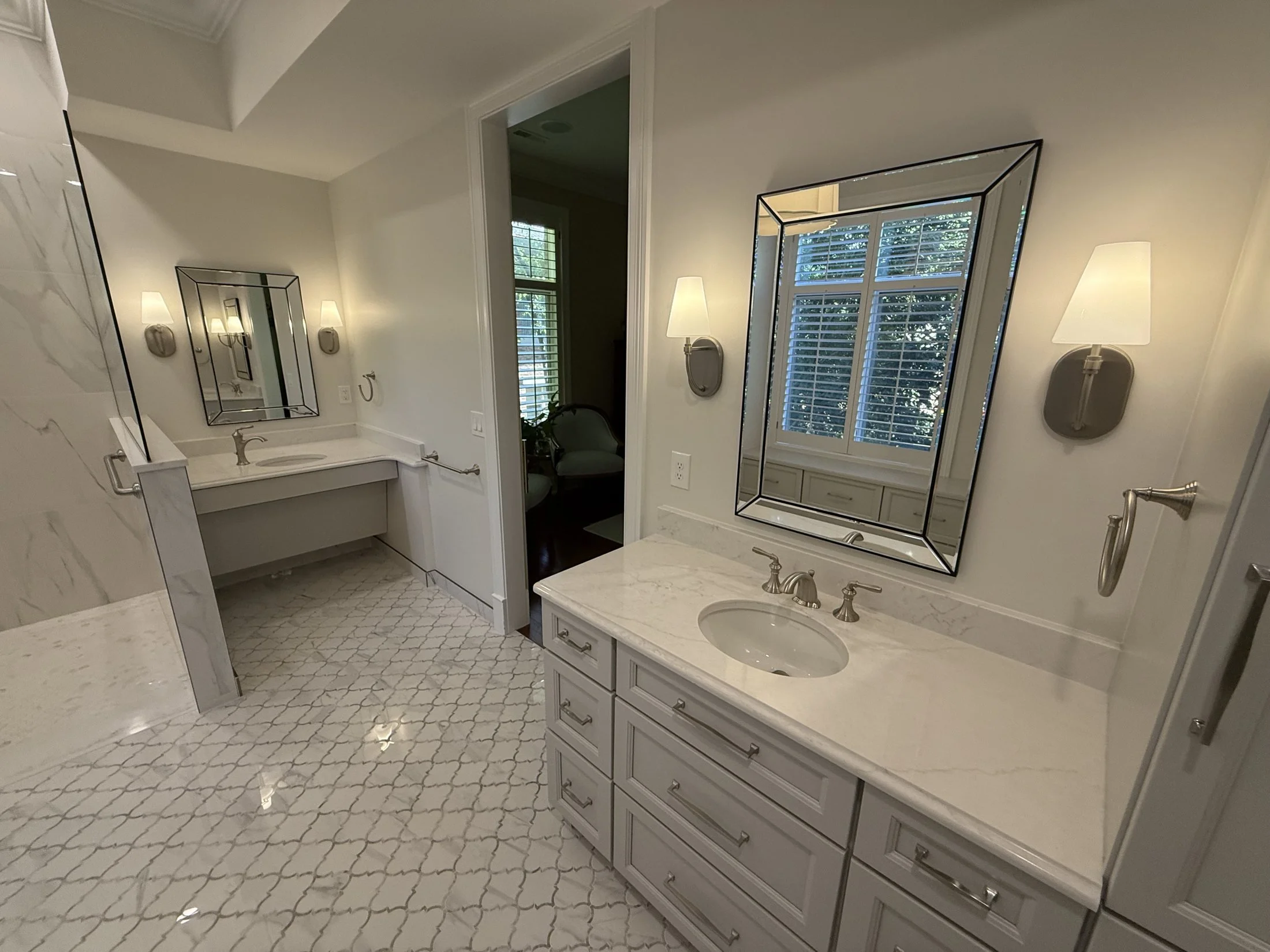 Vanity with a marble-look countertop and sconces