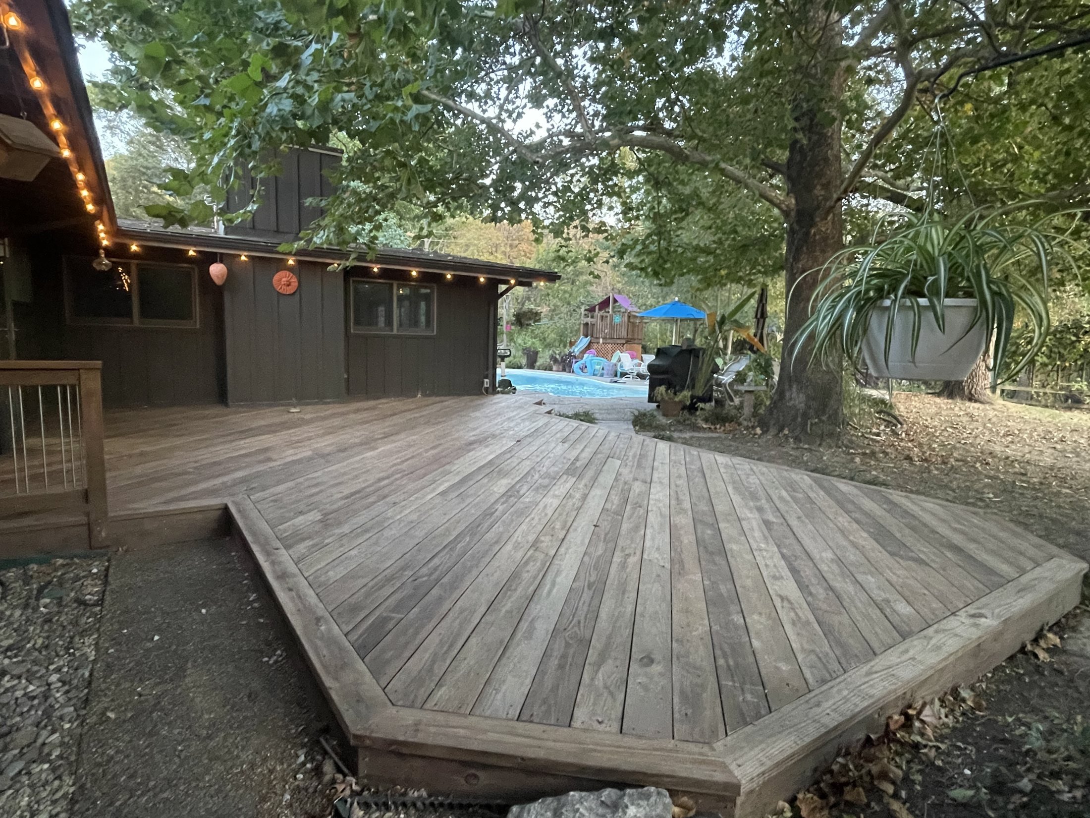 Angled wood deck under mature trees