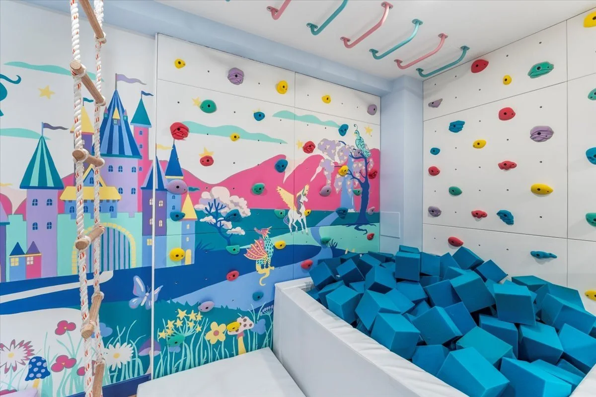 Climbing wall and foam pit with a castle mural