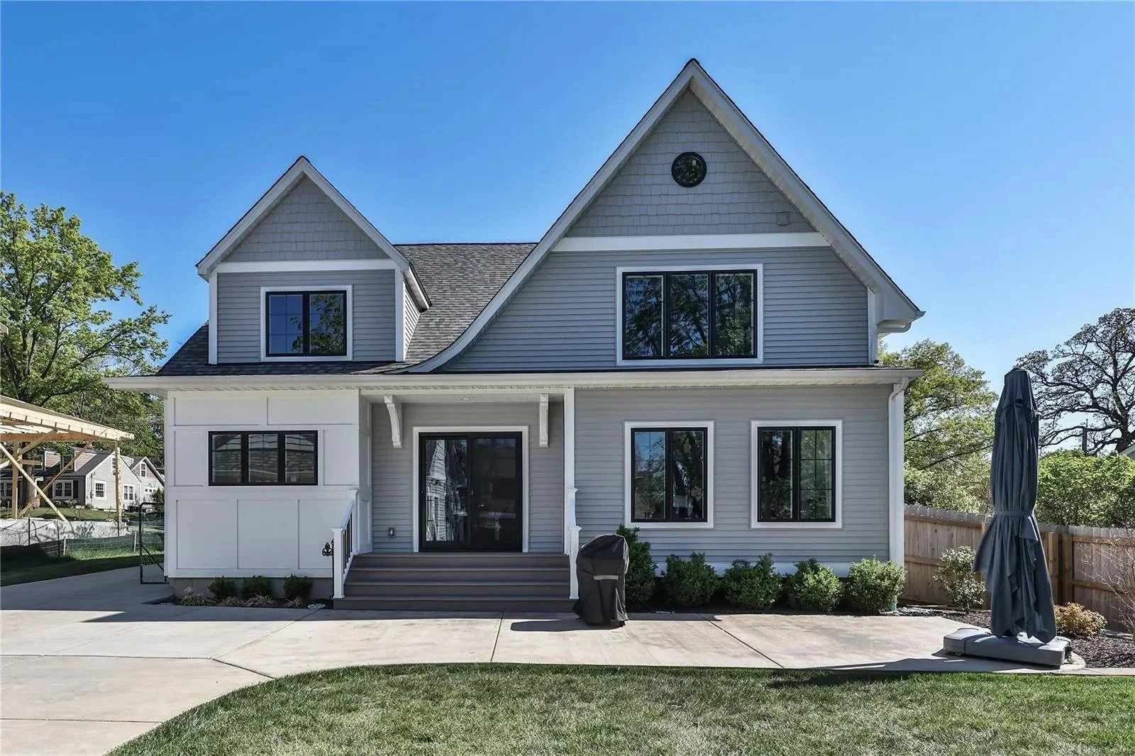 Rear of the custom home with a covered patio
