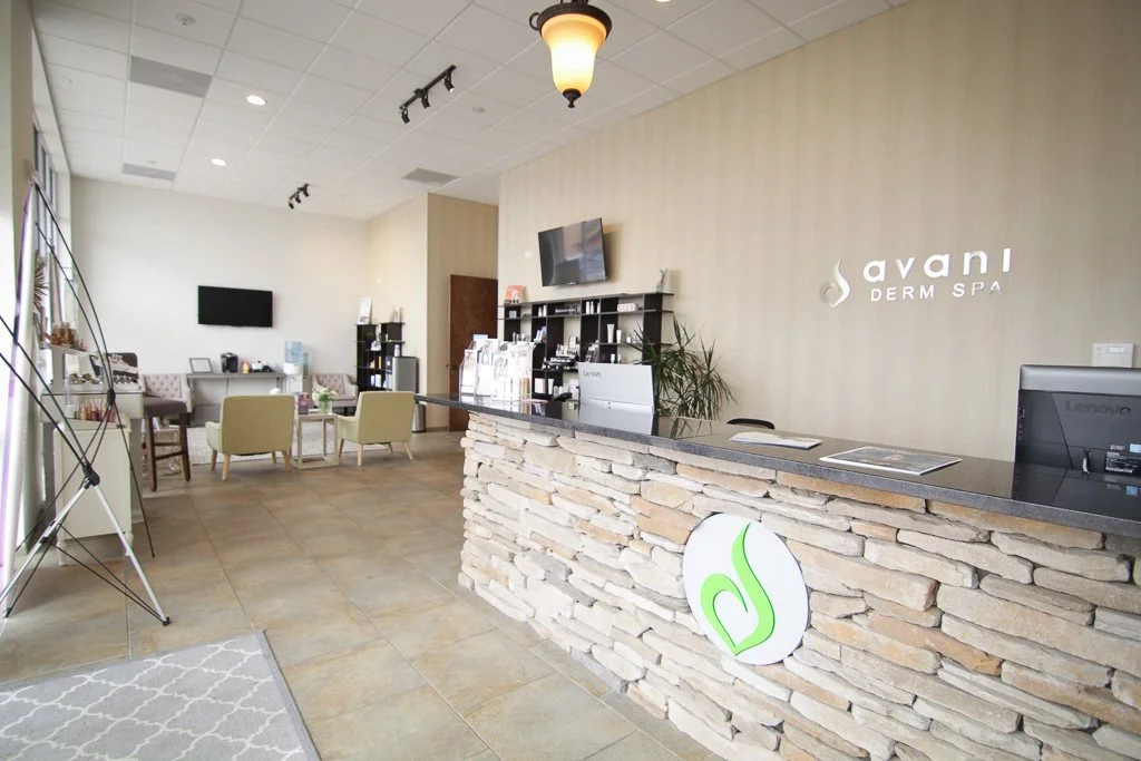 Med spa reception with a stacked-stone desk