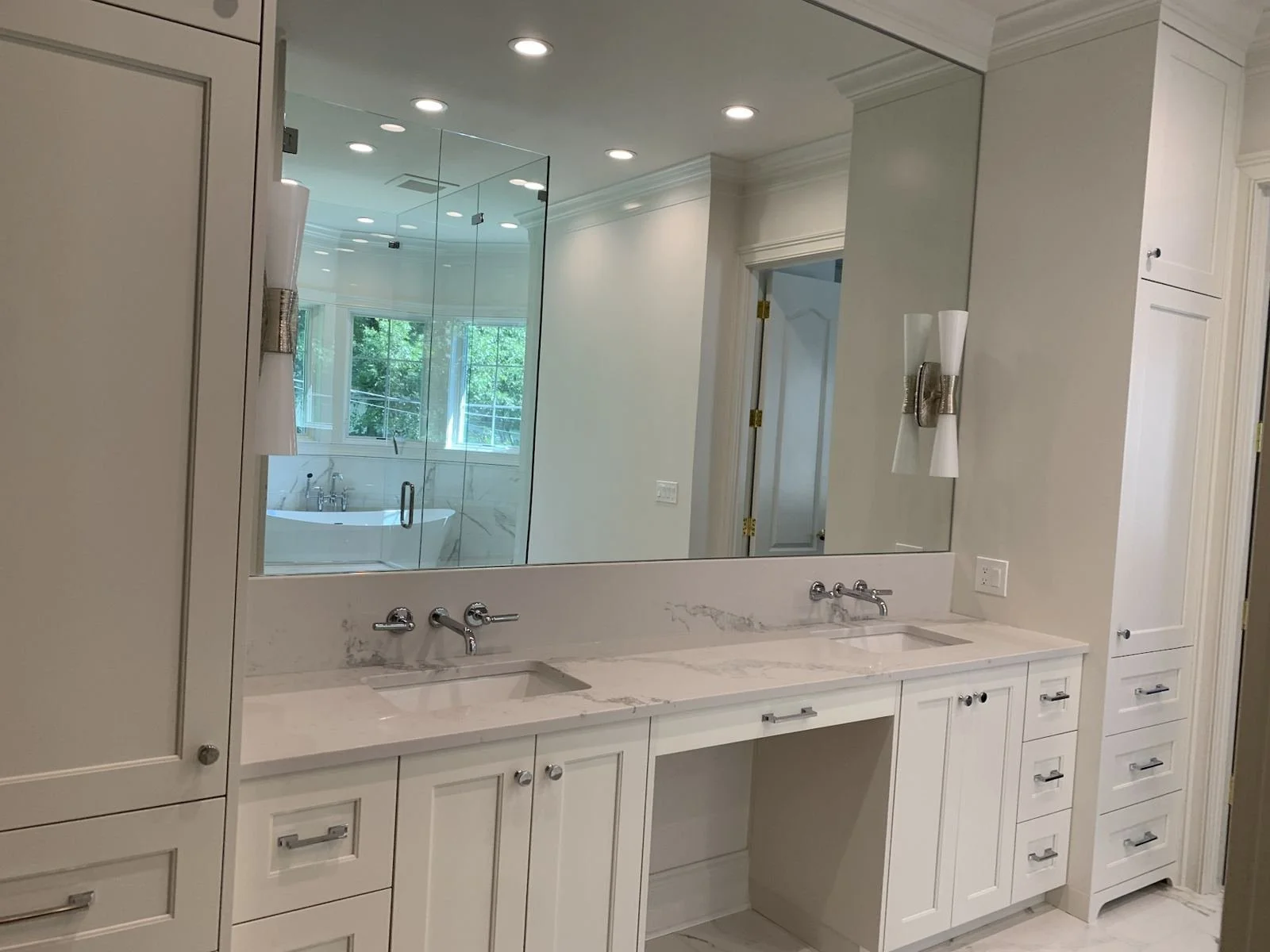 Primary bathroom with a double vanity and large mirror