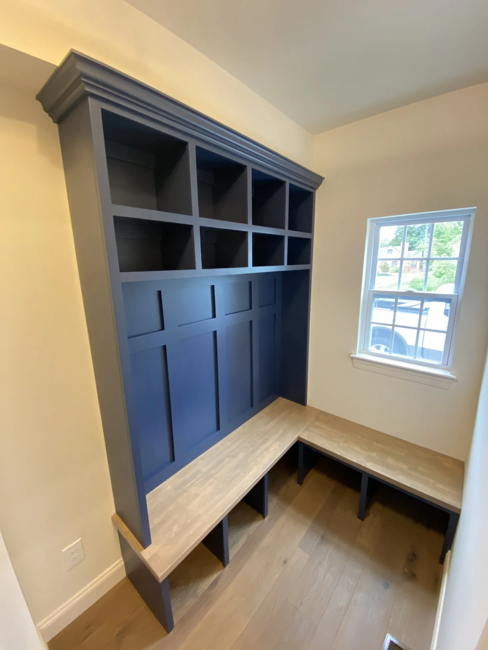 Navy lockers and a natural wood bench