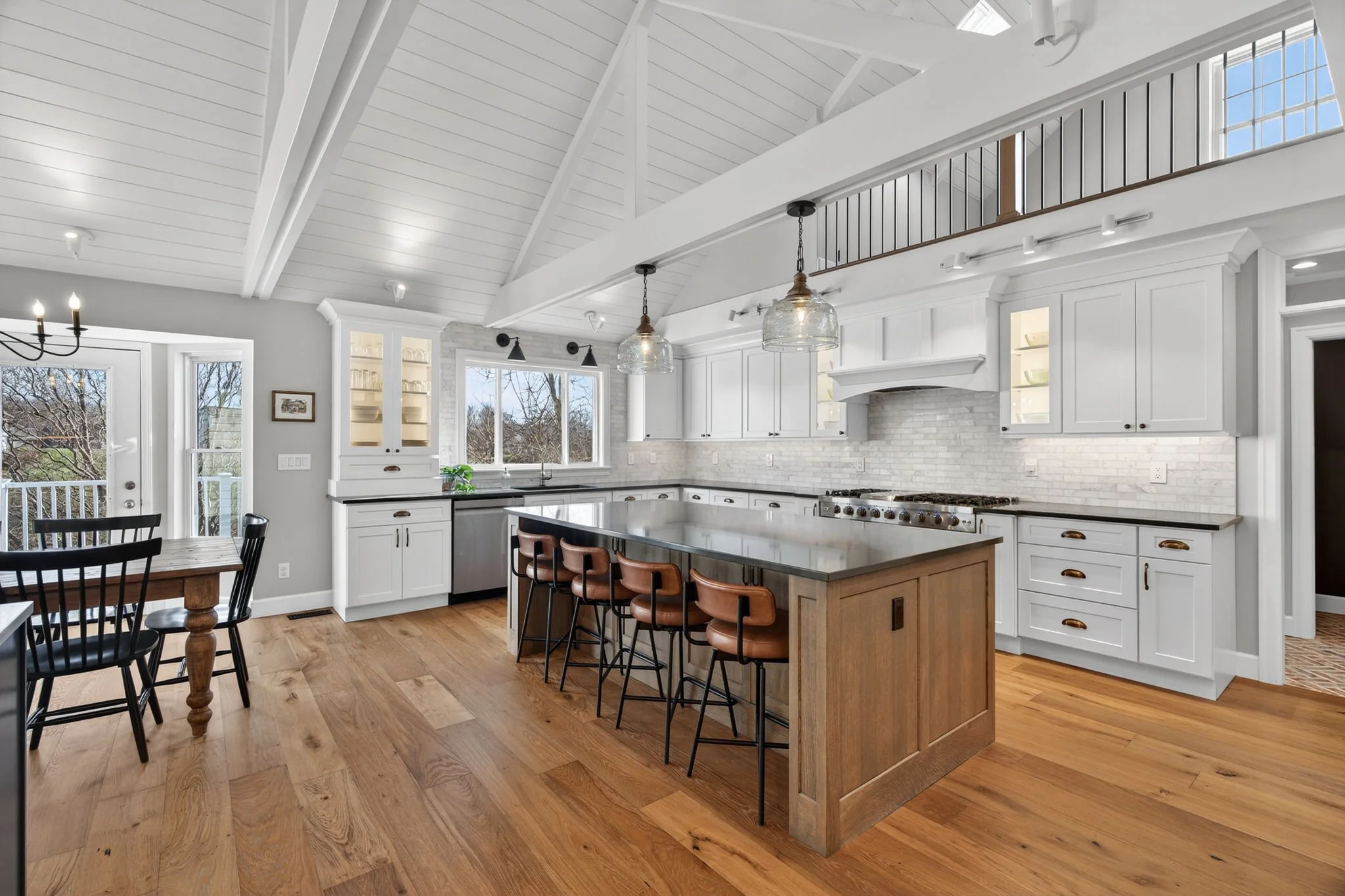 Kitchen island with bar seating under a vaulted ceiling