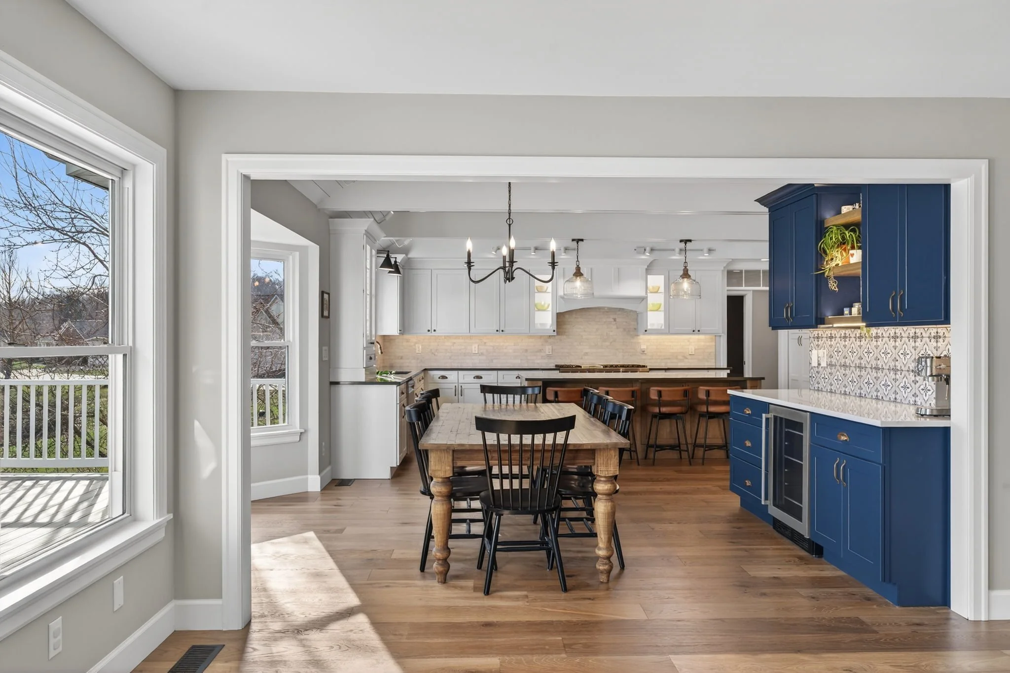 Kitchen with navy cabinetry beside the dining area