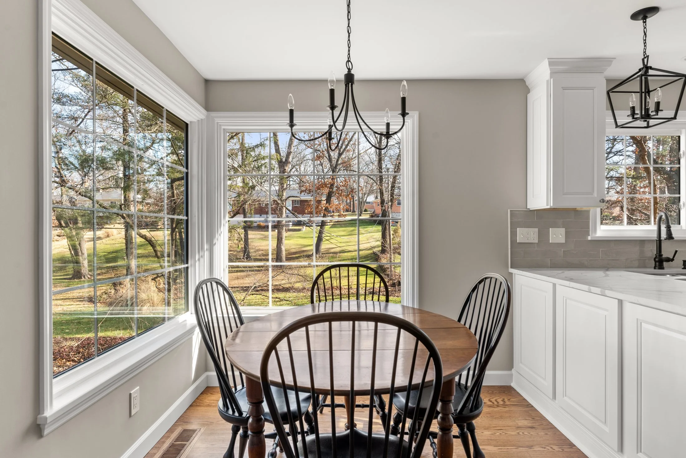 Breakfast nook with large windows and a chandelier