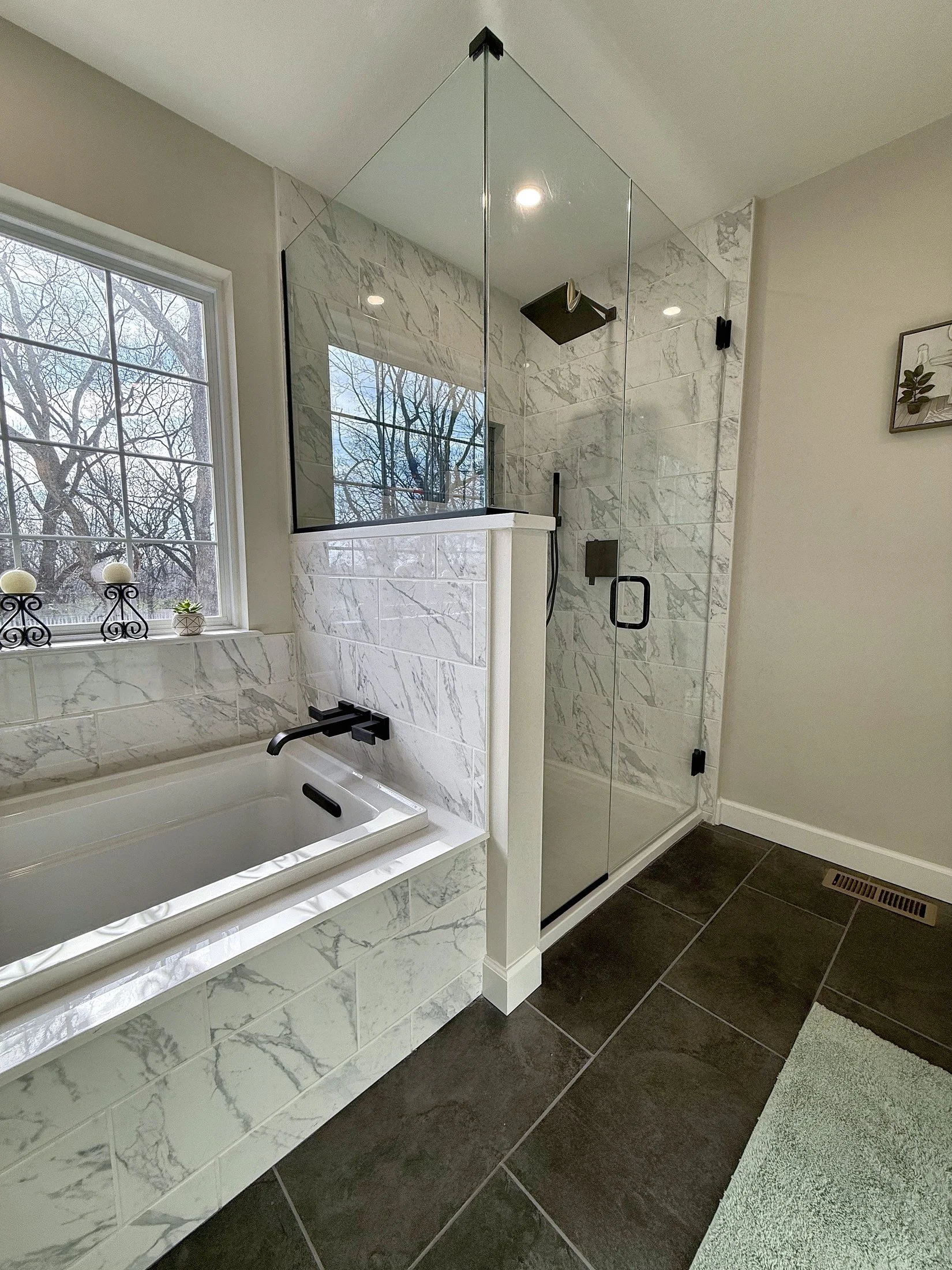 Soaking tub beside the glass shower