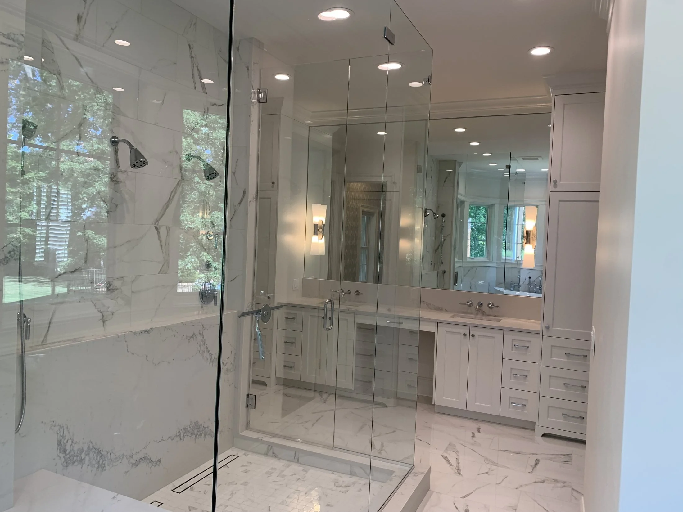 Primary bath with a glass shower and double vanity