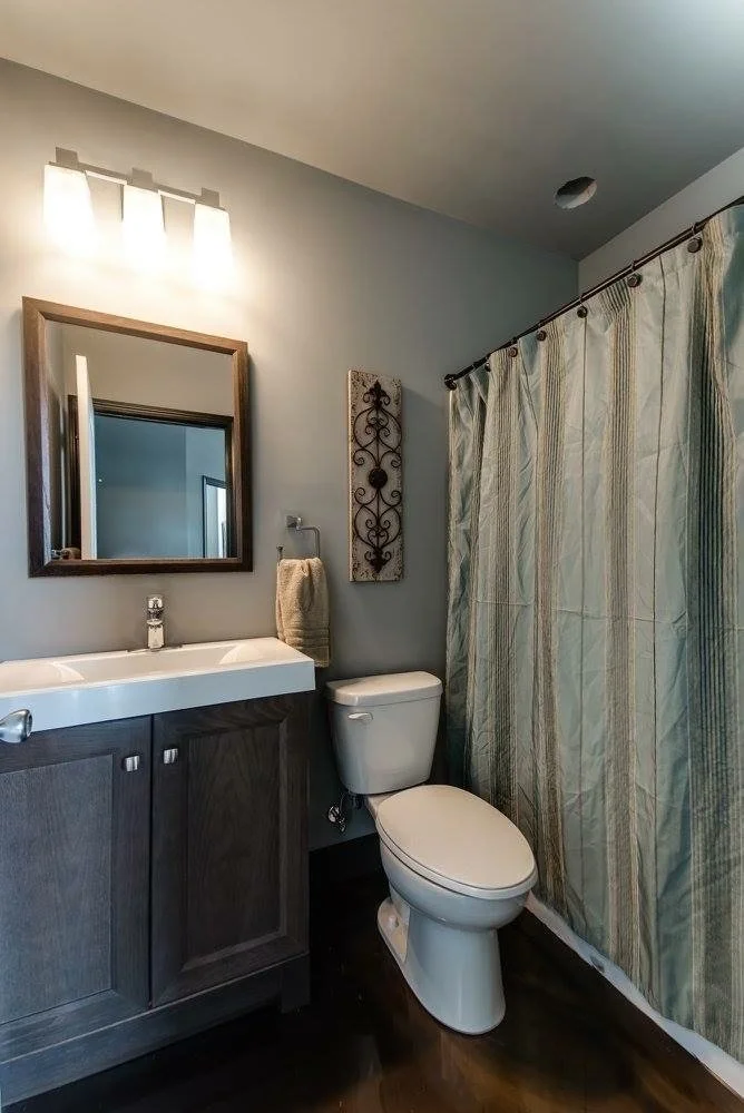 Loft bathroom with a dark vanity