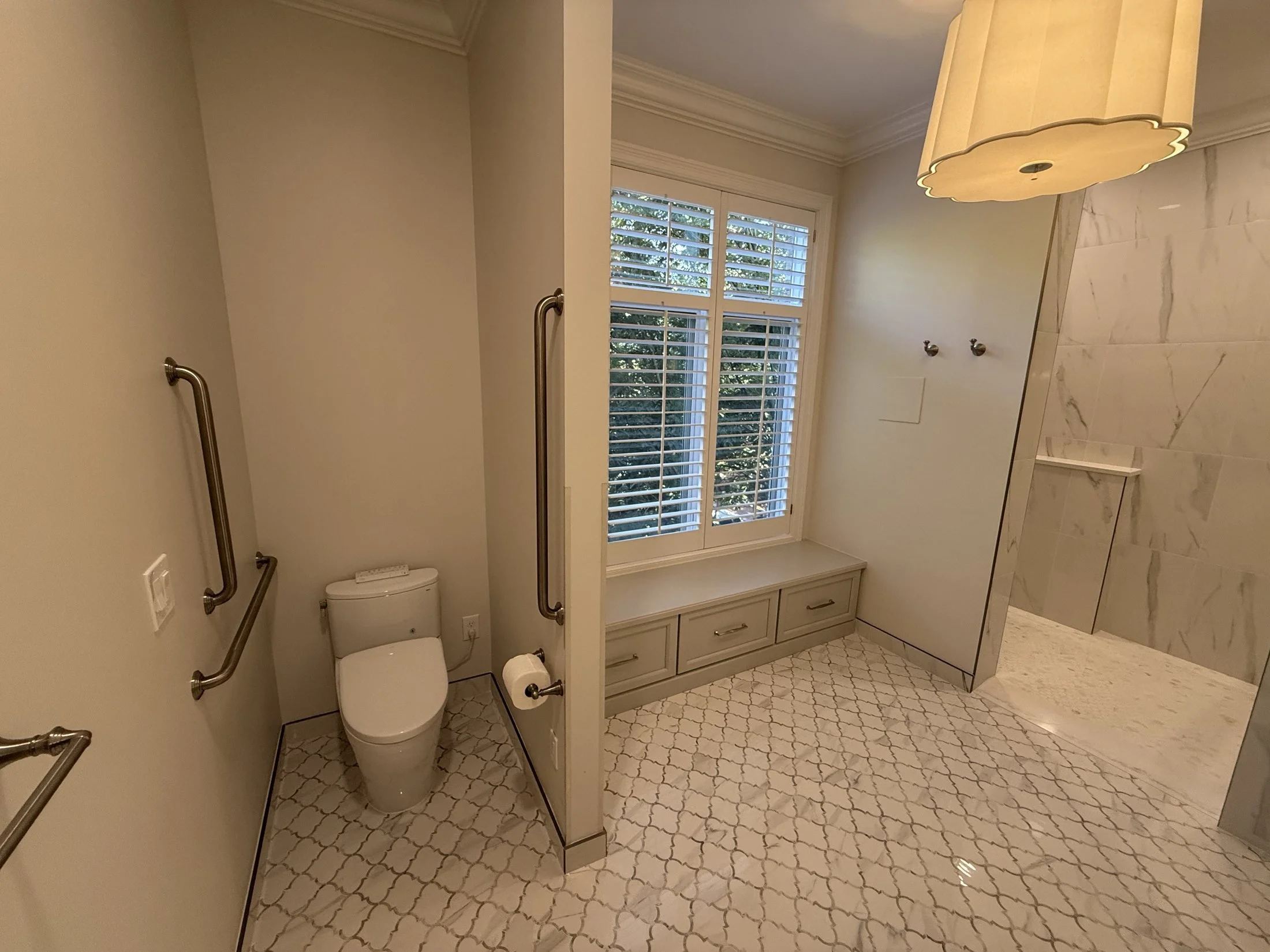 Primary bath with a window seat and tile walls