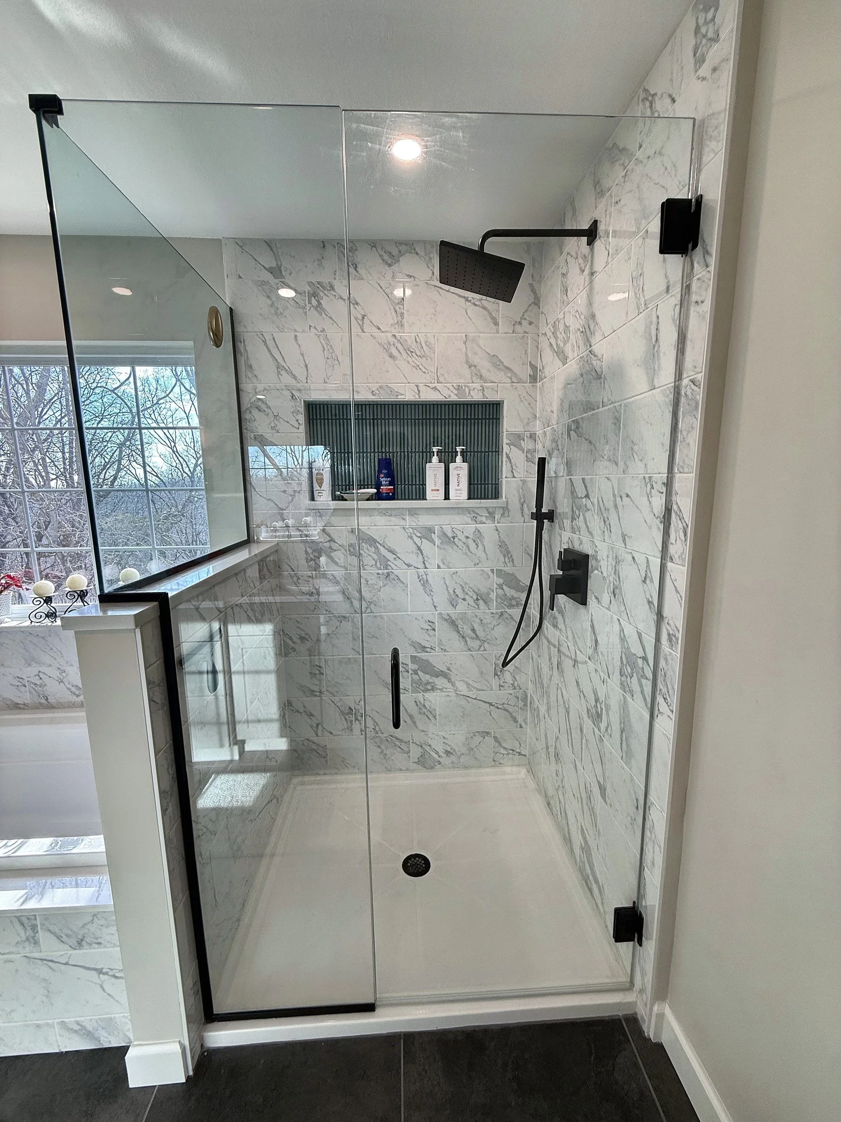 Frameless glass shower with a tiled niche