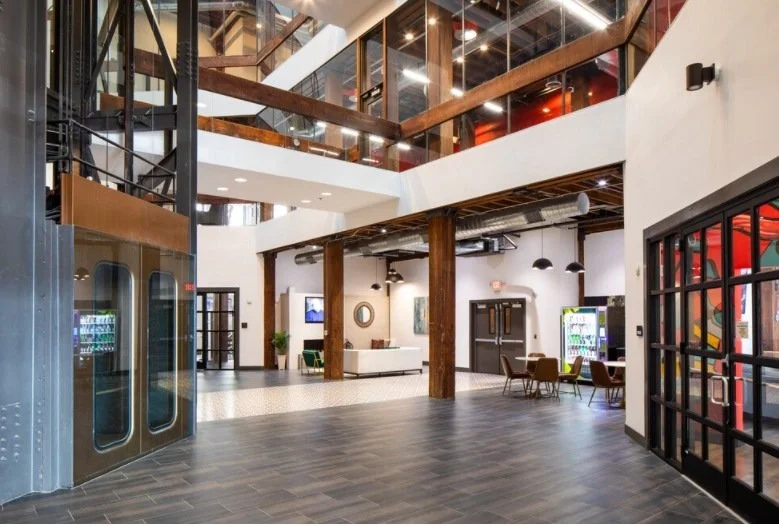Two-story lobby atrium with exposed timber beams