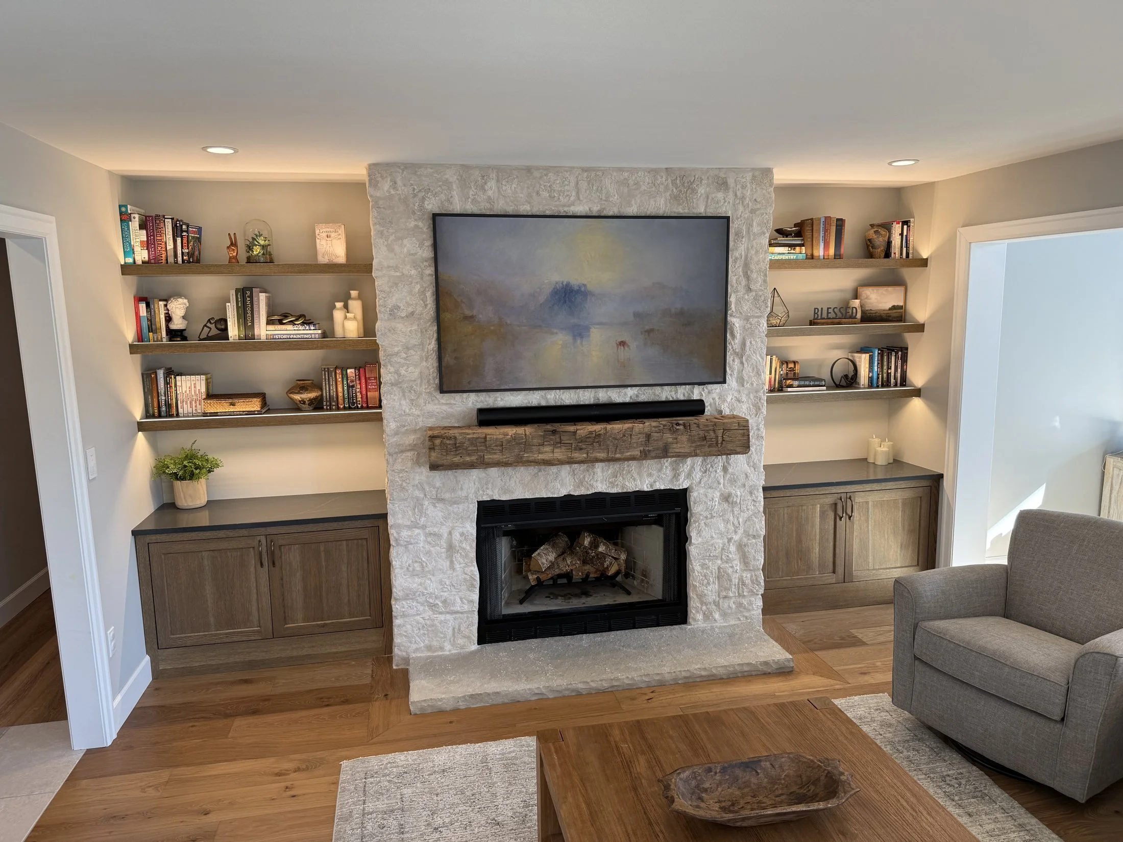Stone fireplace wall with flanking built-ins