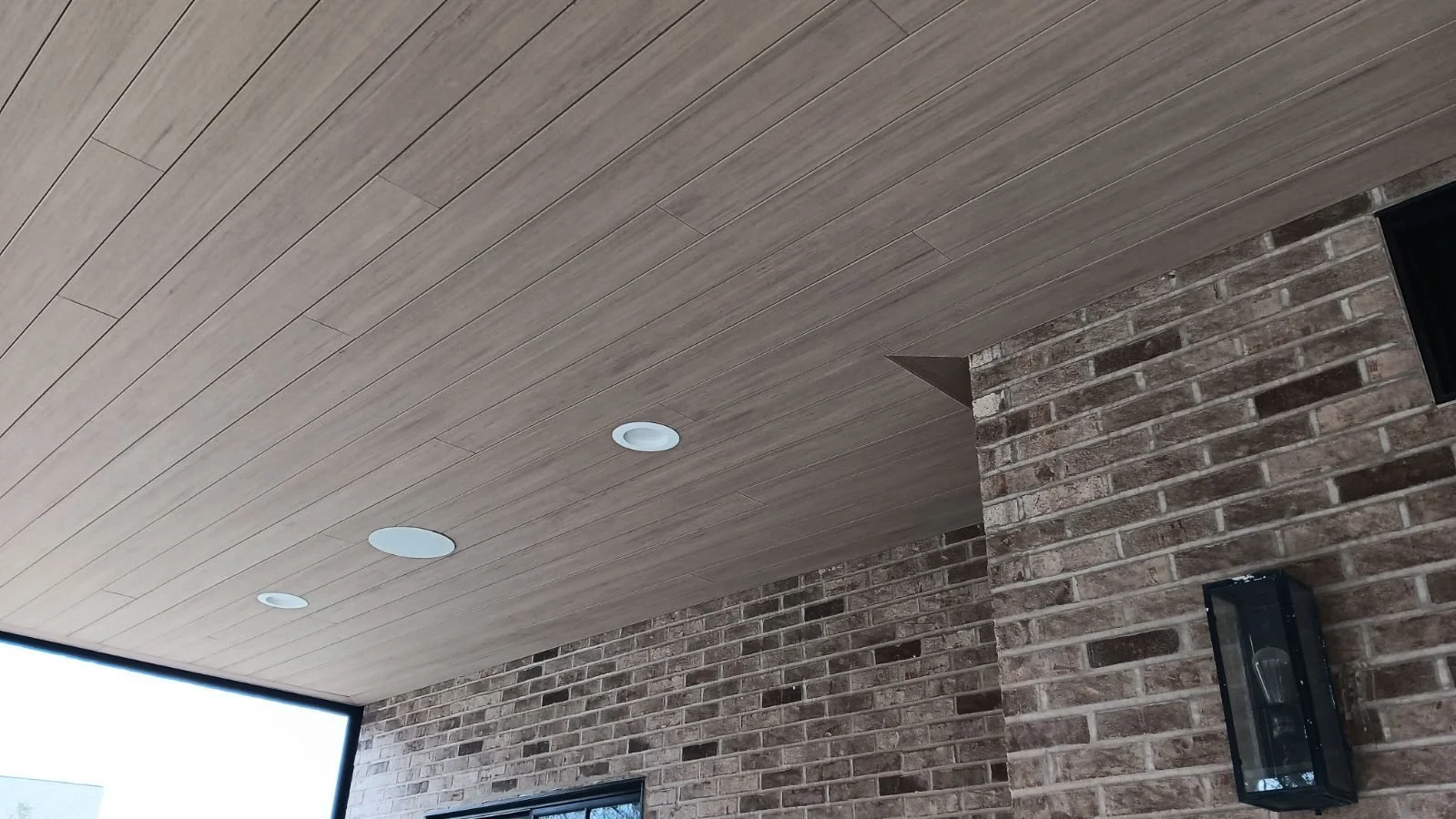 Patio ceiling meeting a brick wall