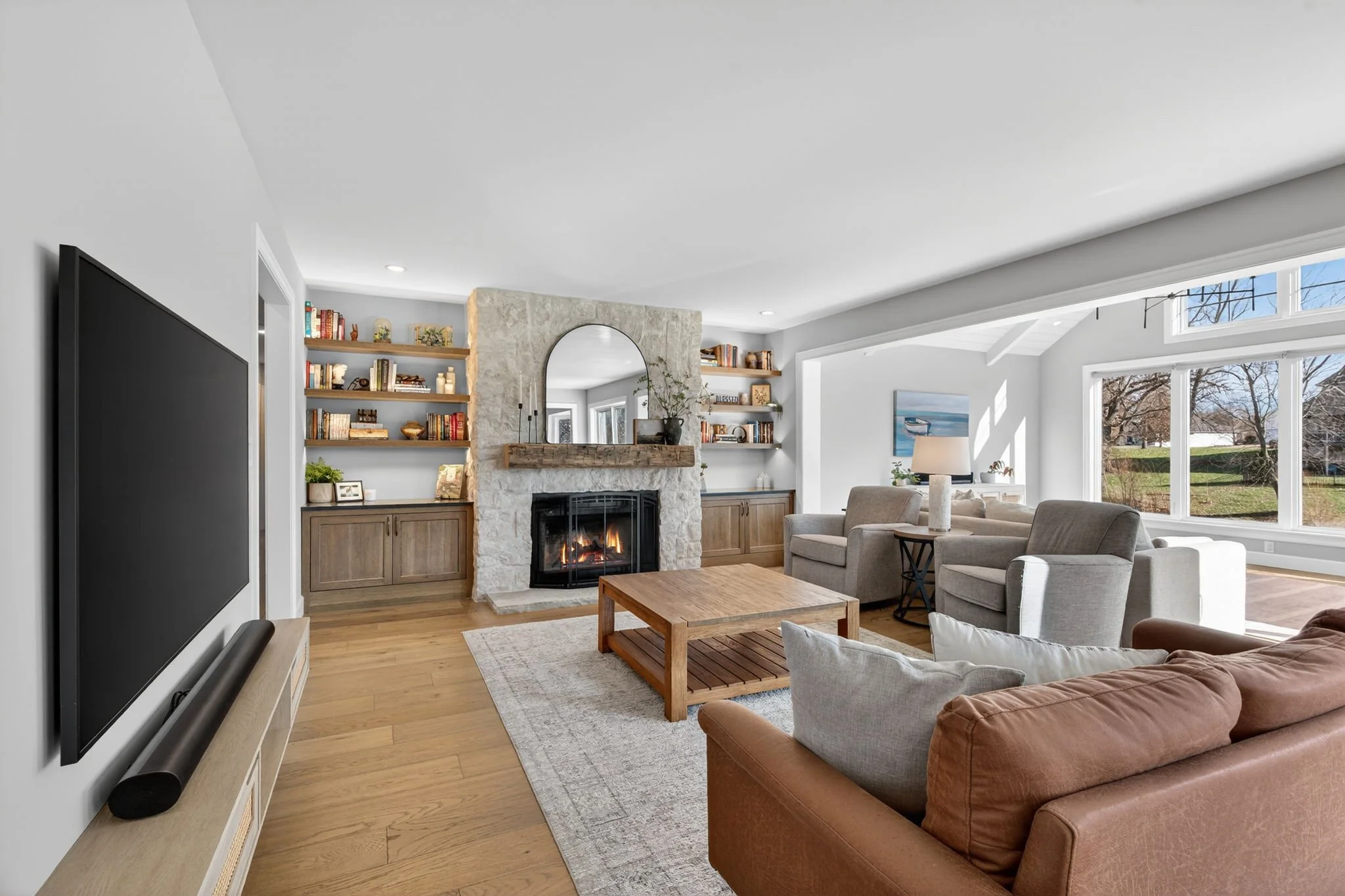 Stone fireplace flanked by built-in shelving