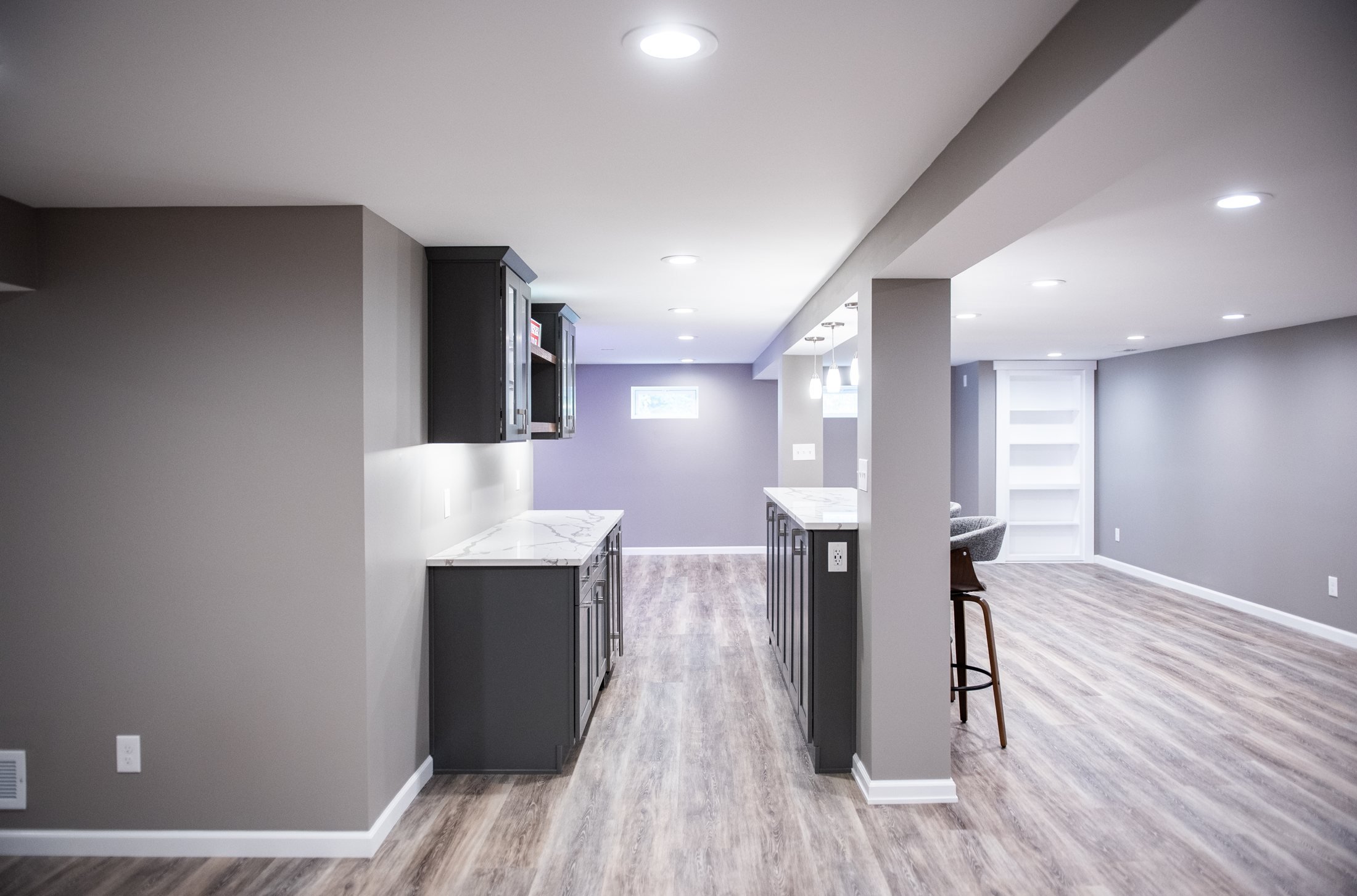 Open basement with a bar and island