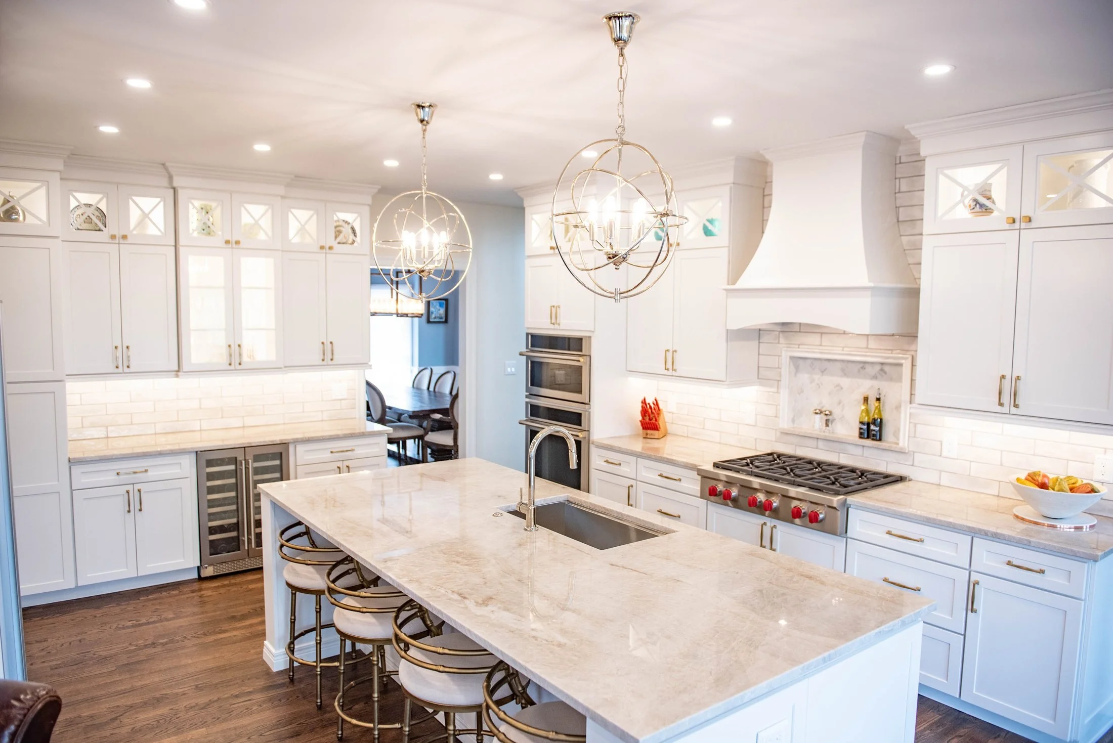 Quartz island with an undermount sink and globe pendants