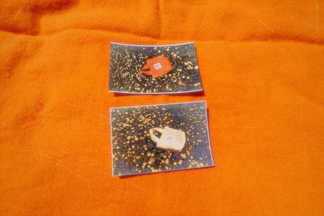 Two small photographs of padlocks placed on an orange fabric surface.