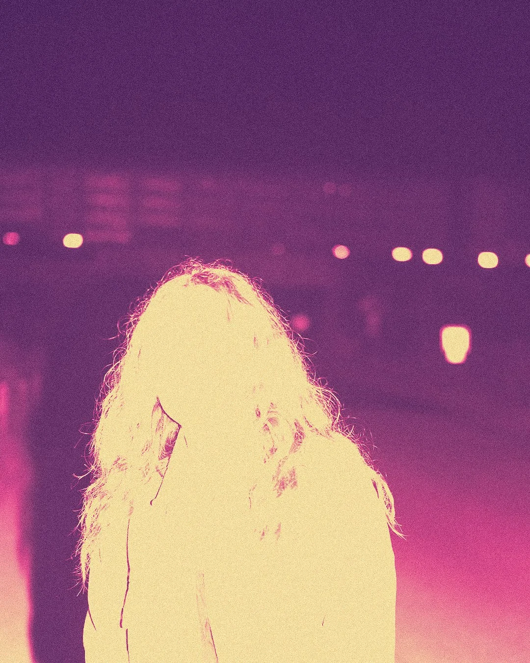 overexposed portrait with neon text overlay in a dark outdoor setting, experimental editorial photography