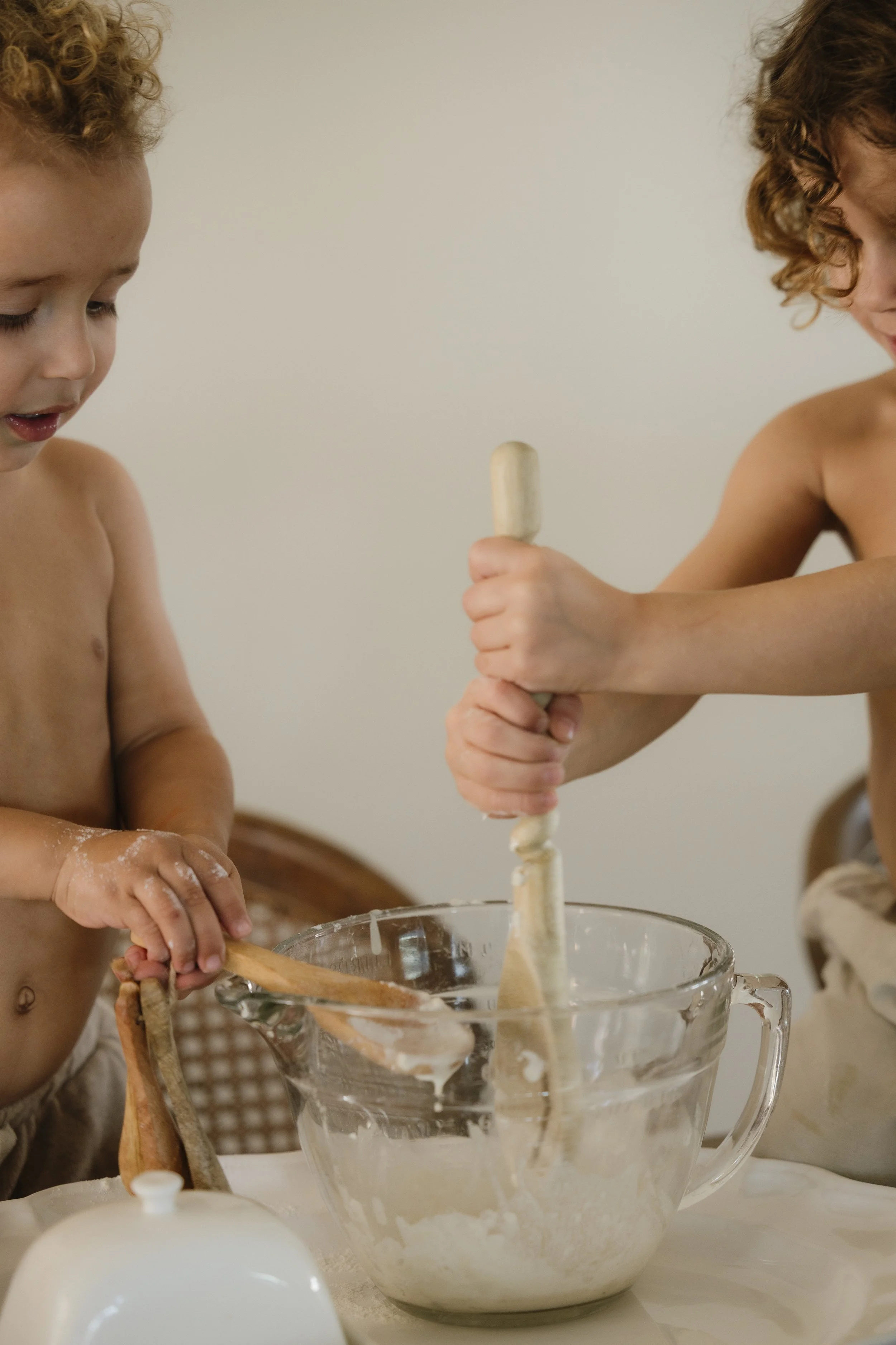 two young children baking together