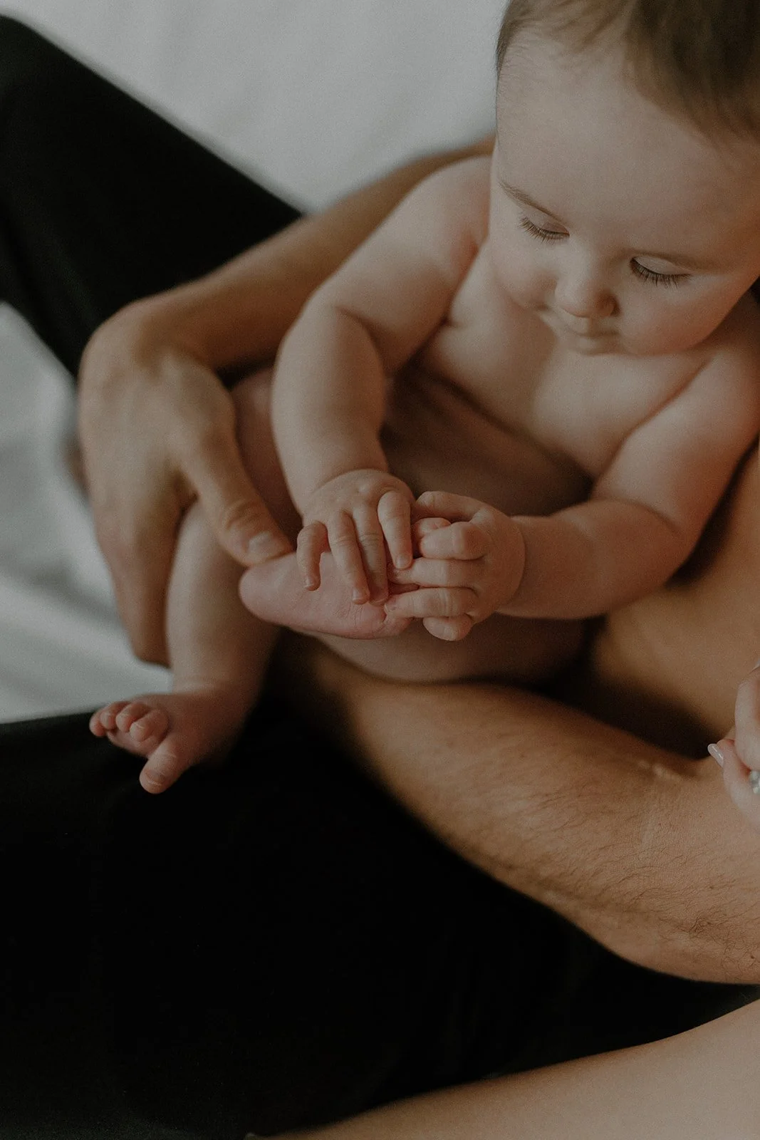 father holding baby in arms