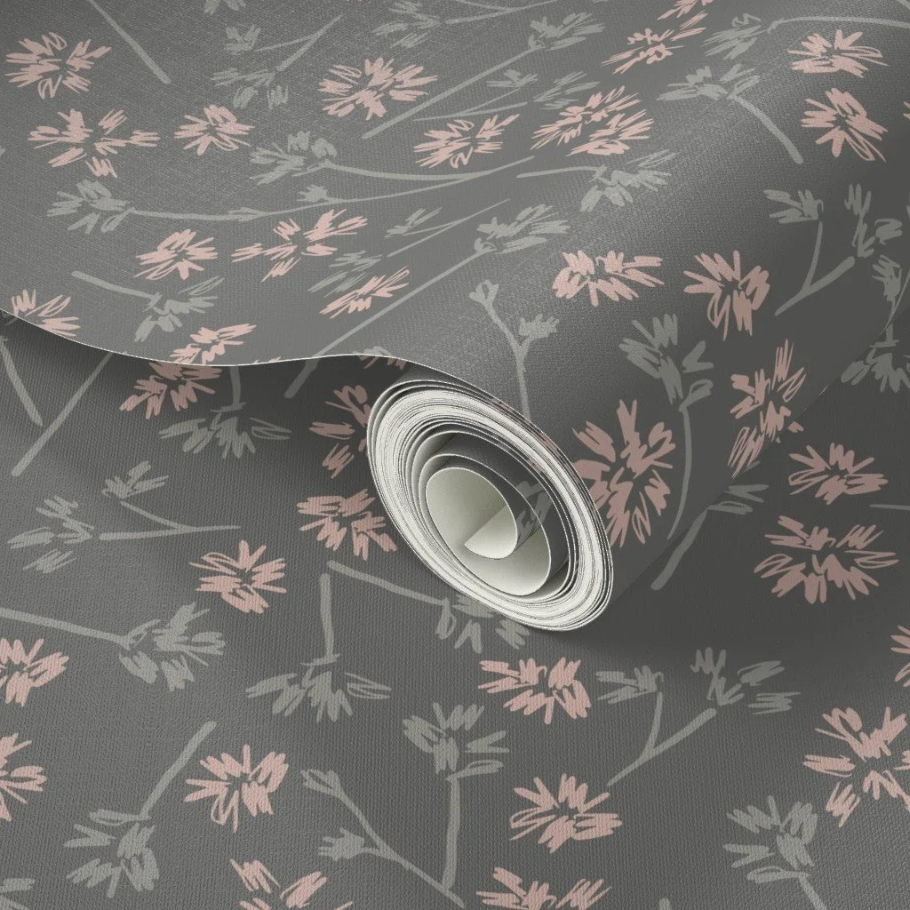 A roll of wallpaper with a gray background and pink and gray floral pattern.