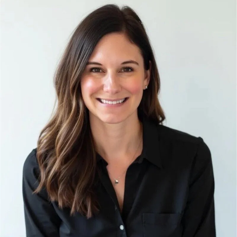 A photo of Amanda Lunt, a smiling woman with long, wavy brown hair. Owner and founder of Blueprint Property Partners.