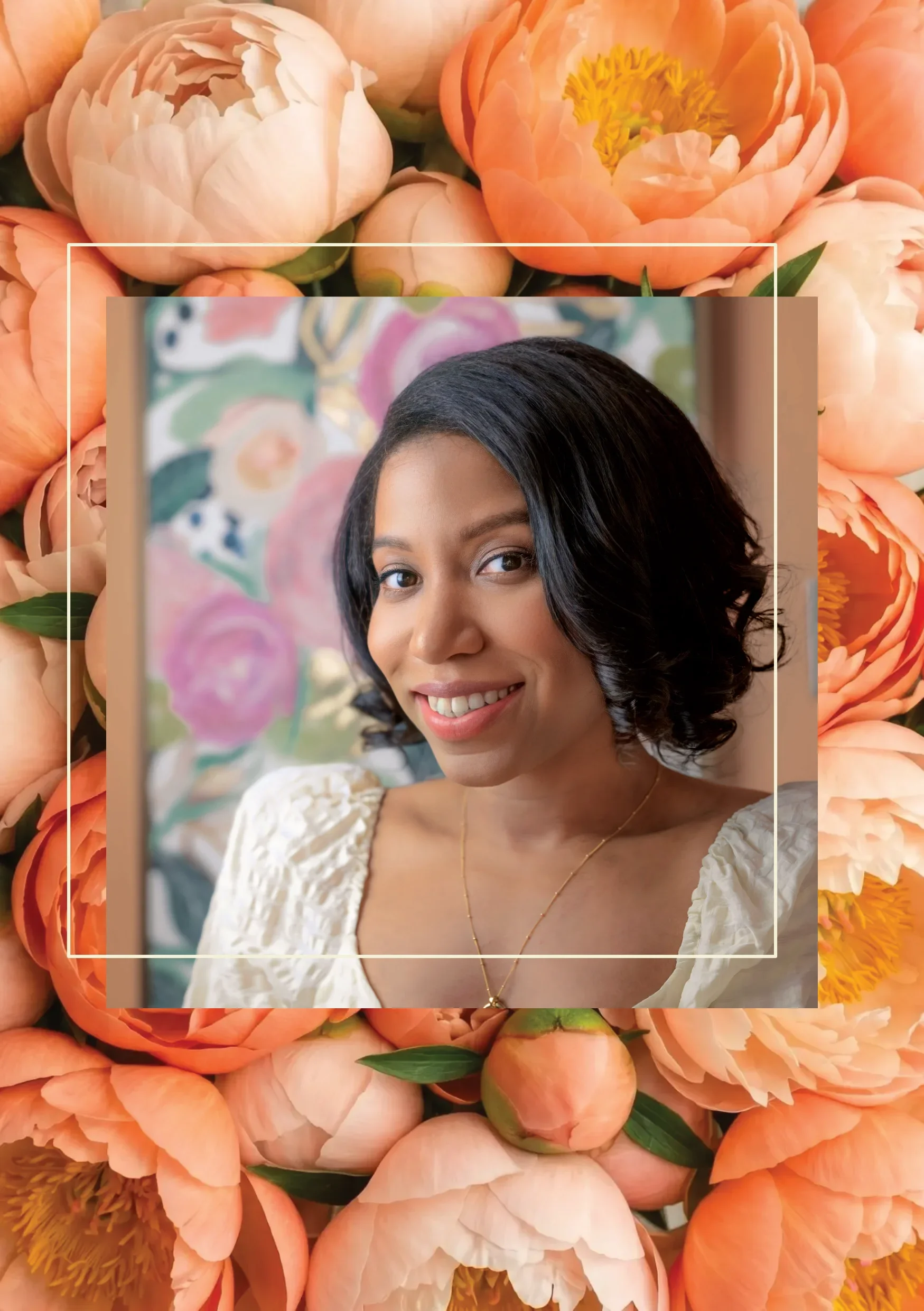 Gina Davis with short black hair and a light complexion smiling at the camera, wearing a white textured blouse and gold necklace, with a colorful floral painting in the background. The photo is framed by a border of pink and coral peony flowers.