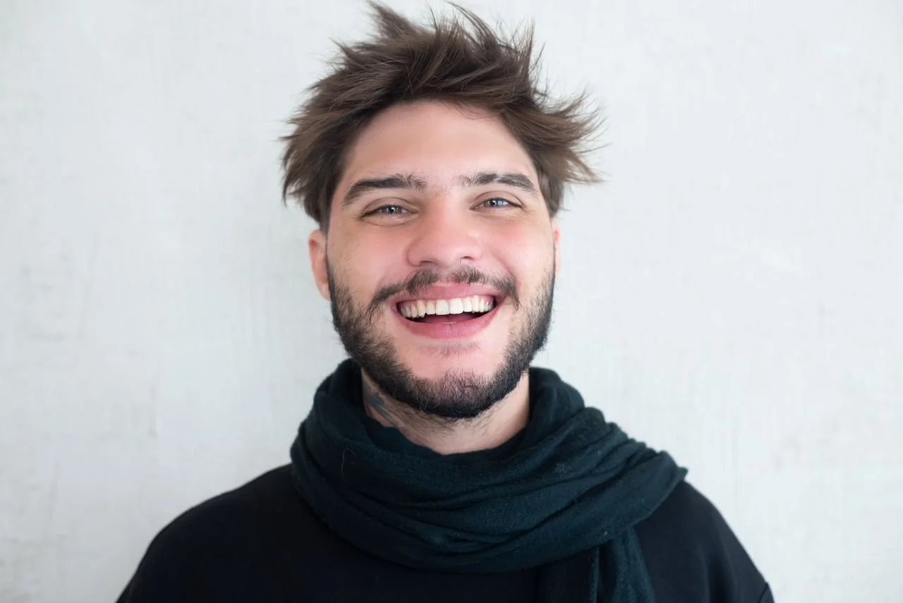 A smiling man looking thoughtful, representing a client experiencing emotional relief and resilience through EMDR therapy for complex trauma.
