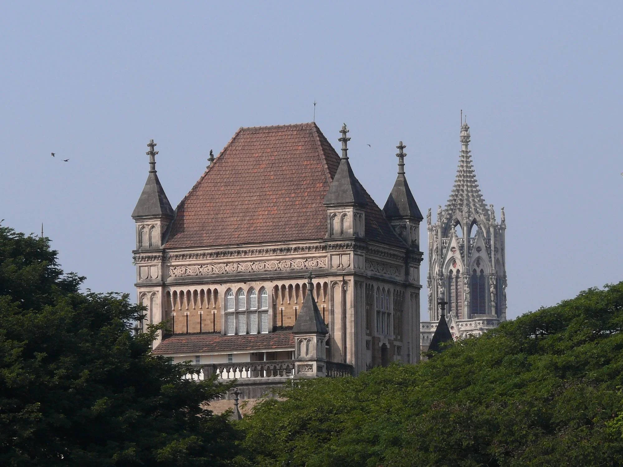 Elphinstone College (1871), Bombay (Mumbai), by James Trubshawe. Tower of Bombay University in the background.