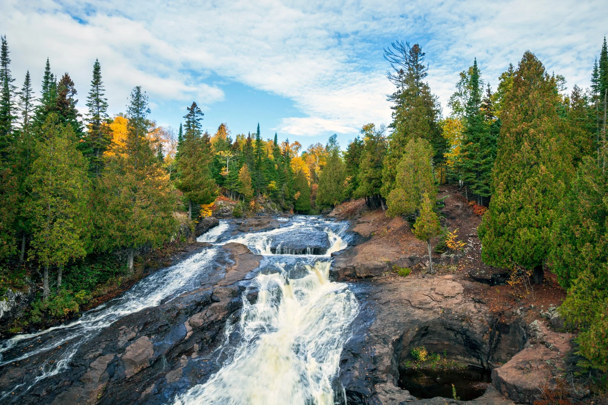 Rushing Cannon River in Minnesota surrounded by woods.