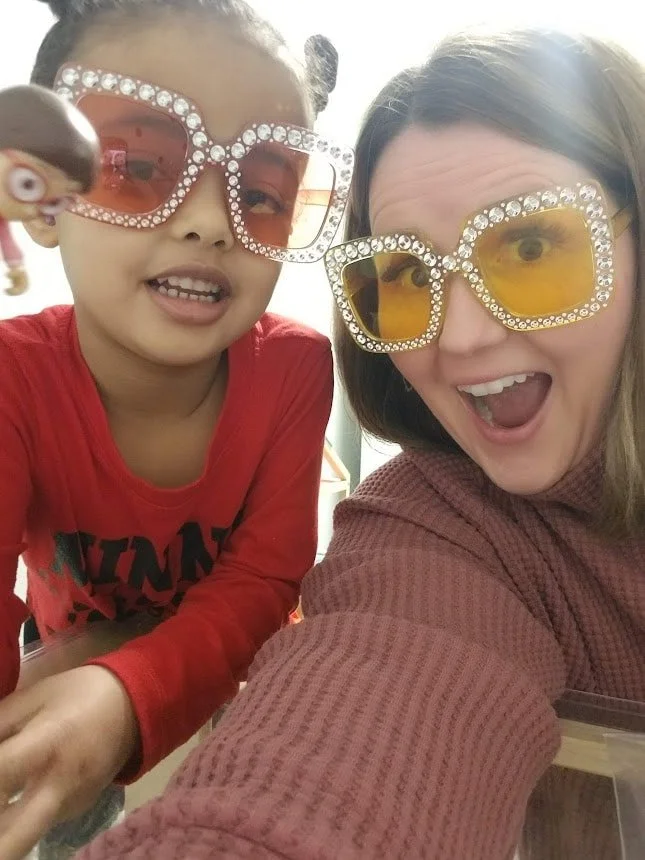Marena and a little girl are wearing Elton John inspired glasses