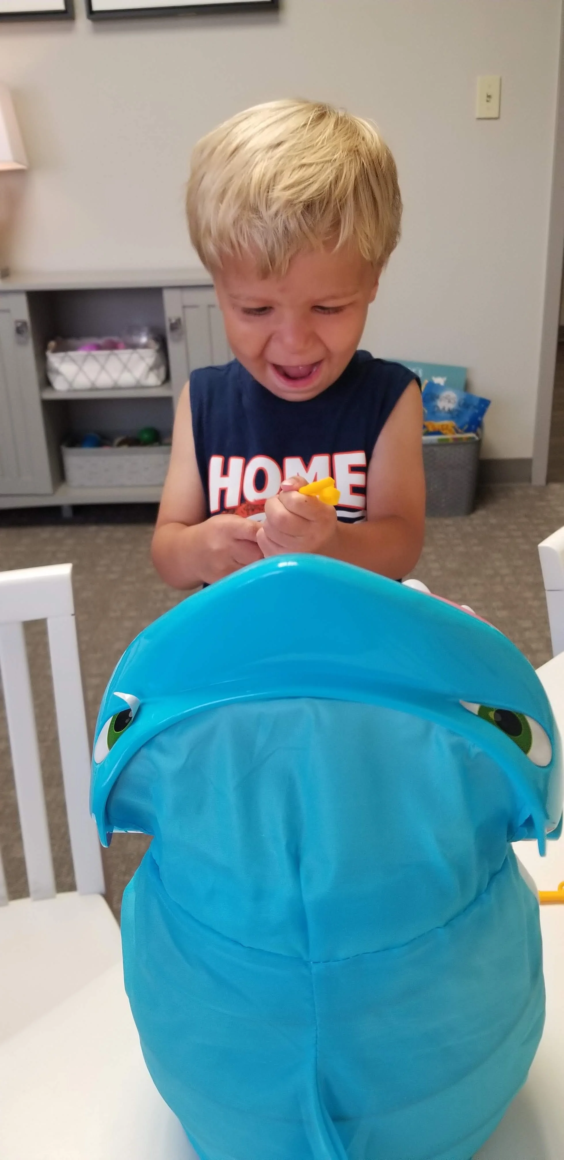 A young boy is looking down playing a game.