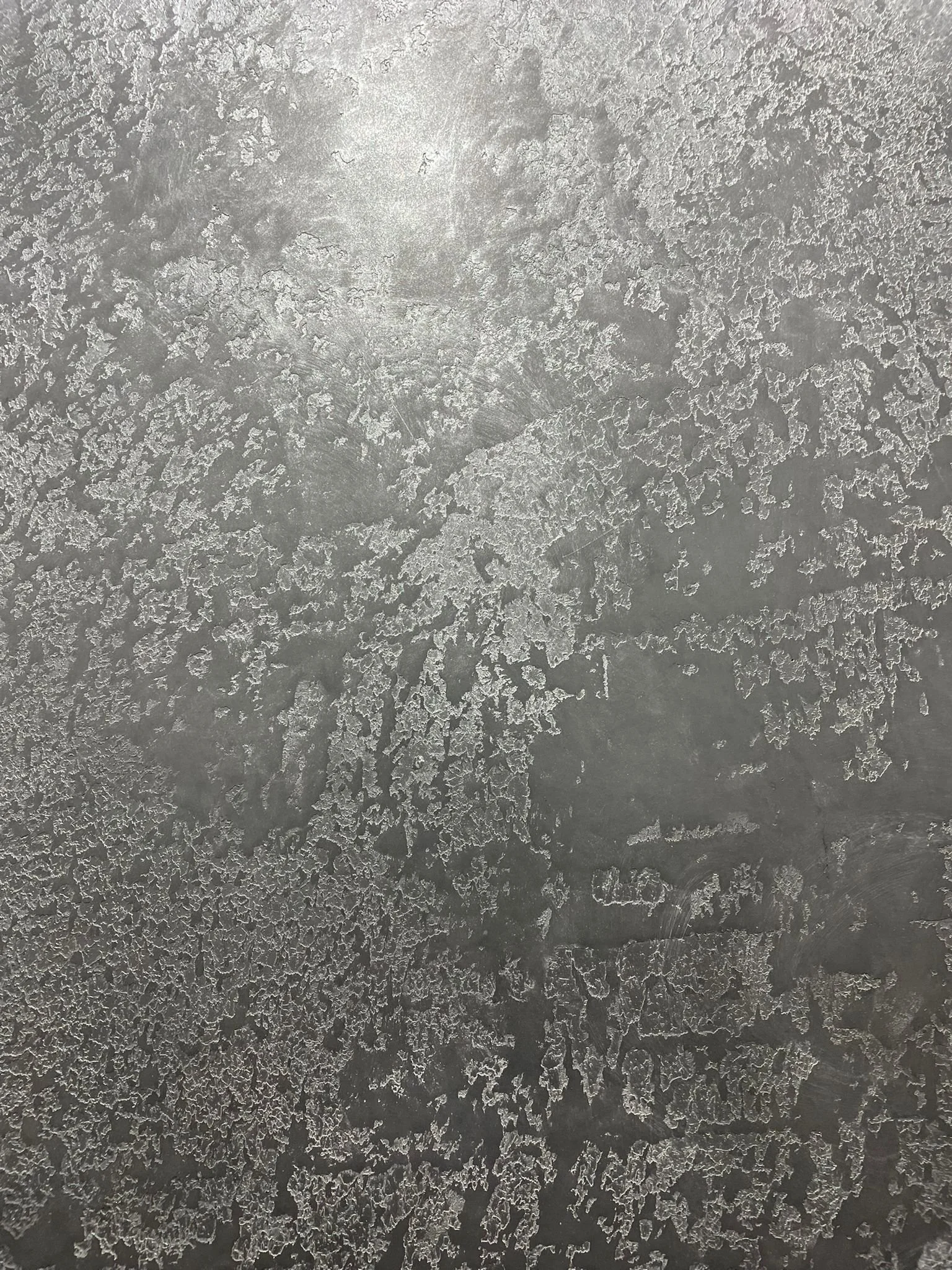 Close-up of a frosted glass surface with intricate ice crystal patterns.
