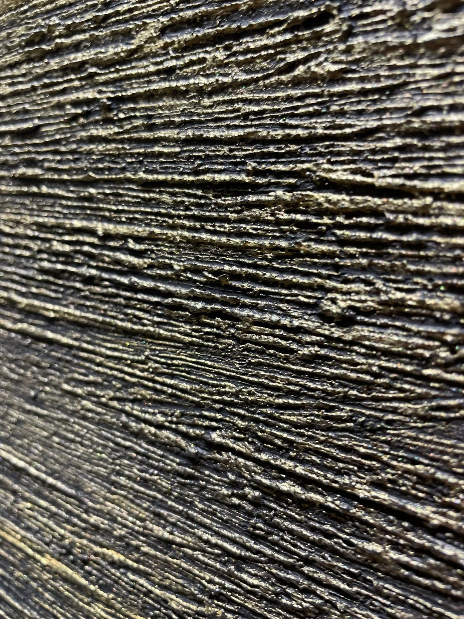 Close-up photo of textured, weathered wood surface with visible grain patterns.