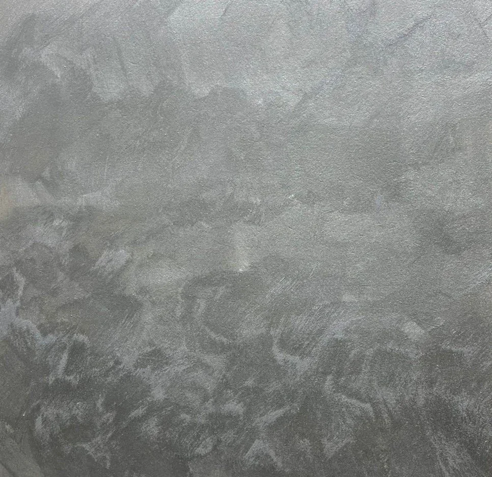 Close-up of a textured gray concrete surface with various patterns and markings.