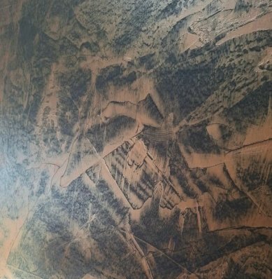 A large satellite image of a landscape with roads, fields, and forested areas.