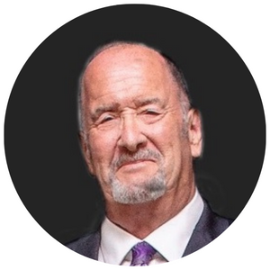 Portrait of an older man with a beard and receding hair, wearing a suit and tie, looking serious.