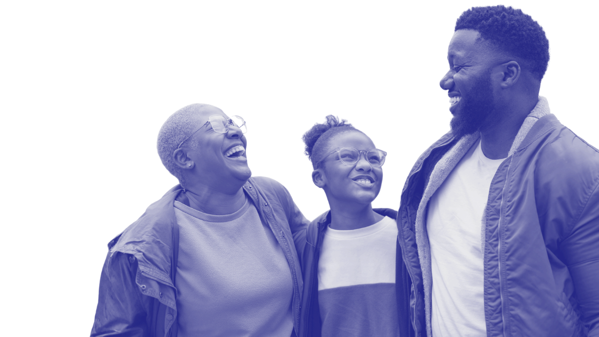 Three happy people, two women and a man, sharing a moment of joy and laughter outdoors.