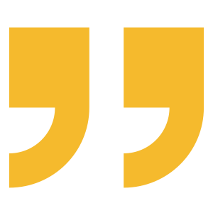 A large pair of yellow quotation marks on a black background.