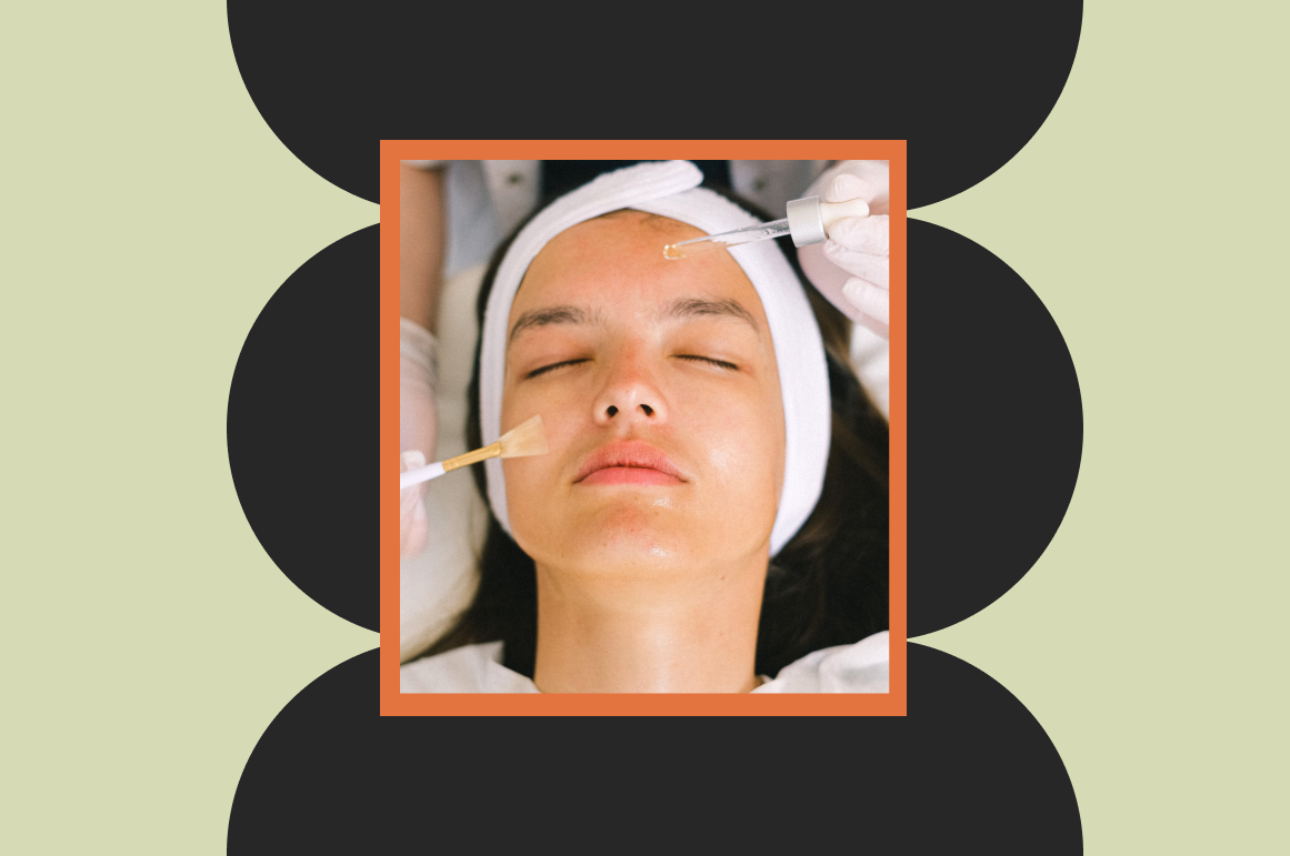 A woman with a headband receiving skincare treatment with two droppers, one applied near her forehead and the other near her cheek, while lying with eyes closed.