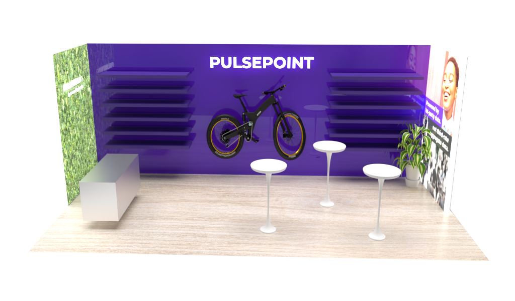 Booth with purple wall displaying a bicycle and the word 'PULSEPOINT', with three white tables, a potted plant, and posters on the side walls.