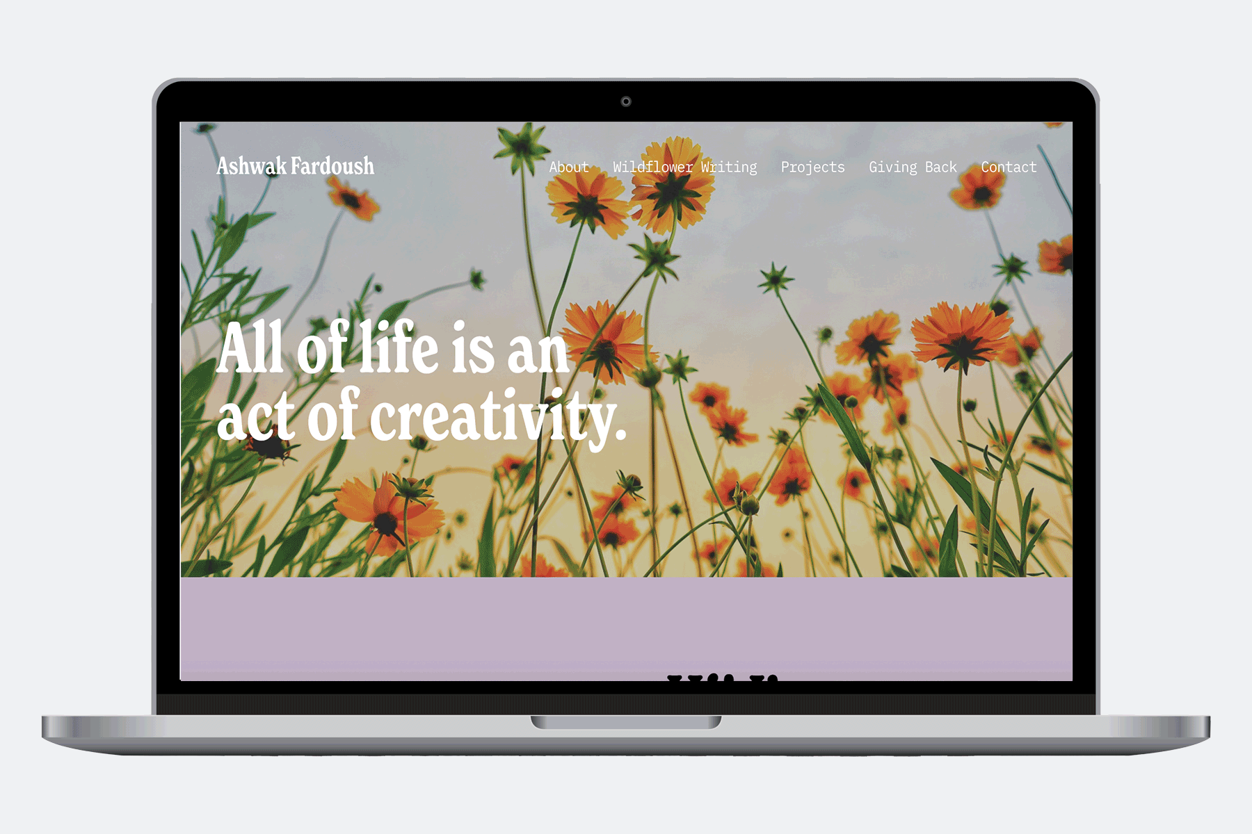 Laptop displaying a website with a background of orange flowers and a quote that reads 'All of life is an act of creativity'.