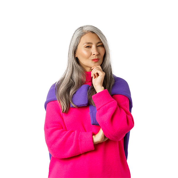 A woman with long gray hair in a pink and purple sweater, holding her chin and looking thoughtful.