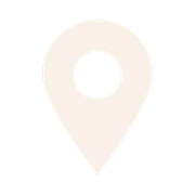 A white map marker icon with a black center on a light background.