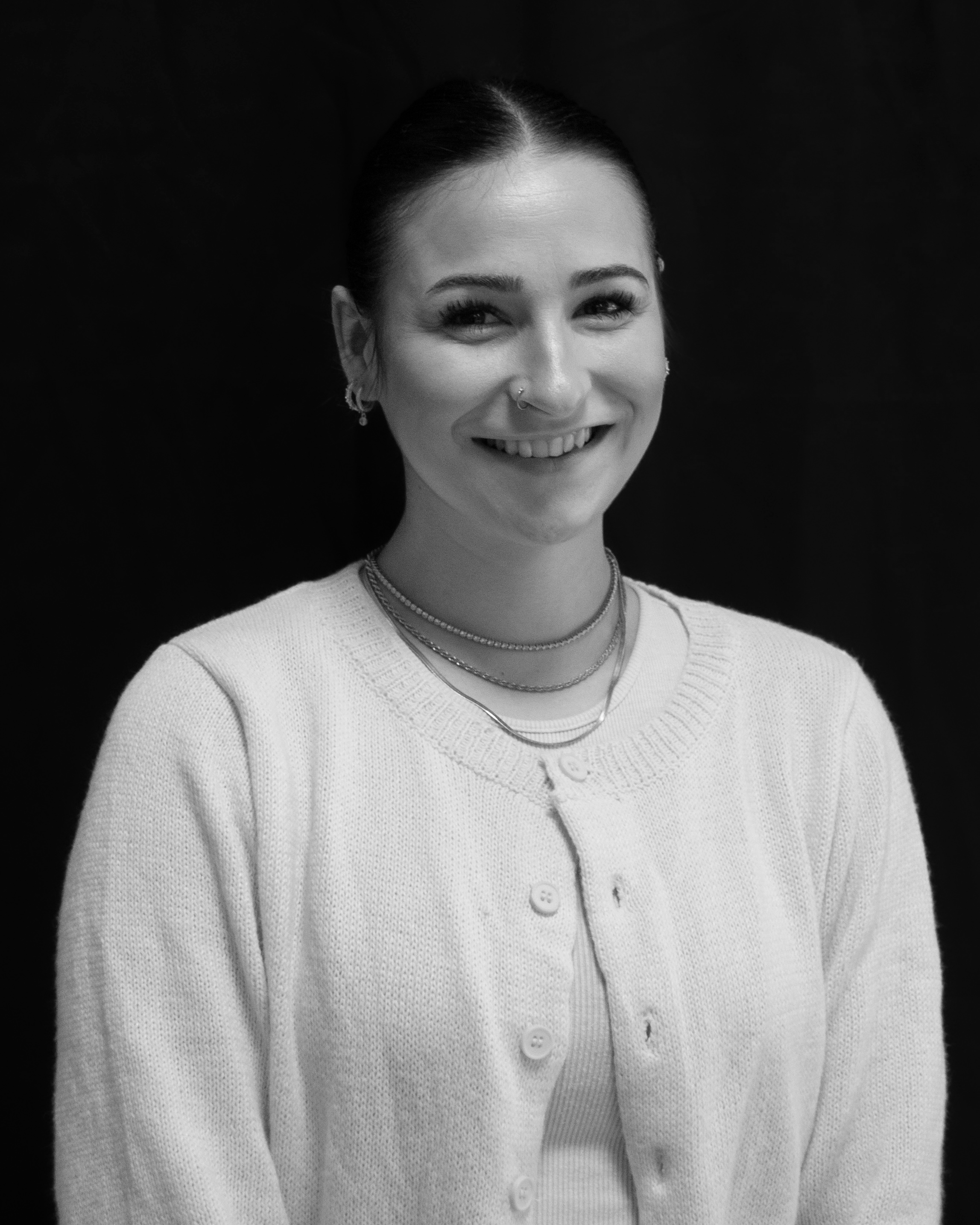 A black and white image of actor Lauren Amirault from the shoulders up