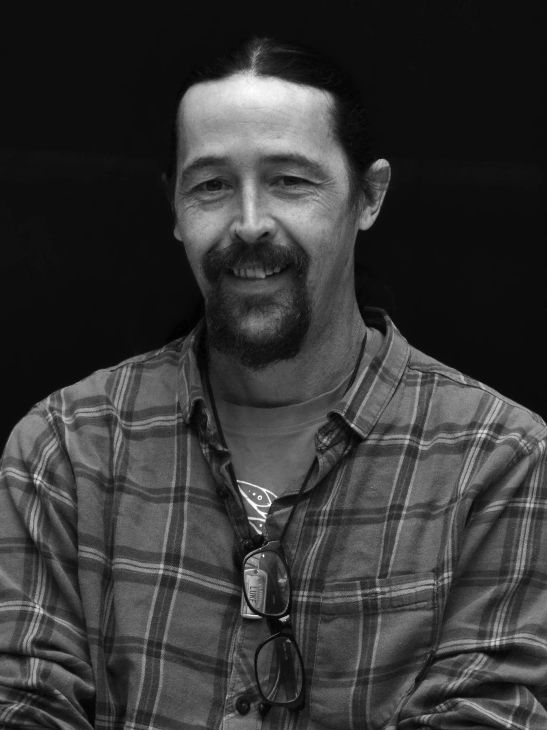 A black and white image of actor Luke Rand from the shoulders up