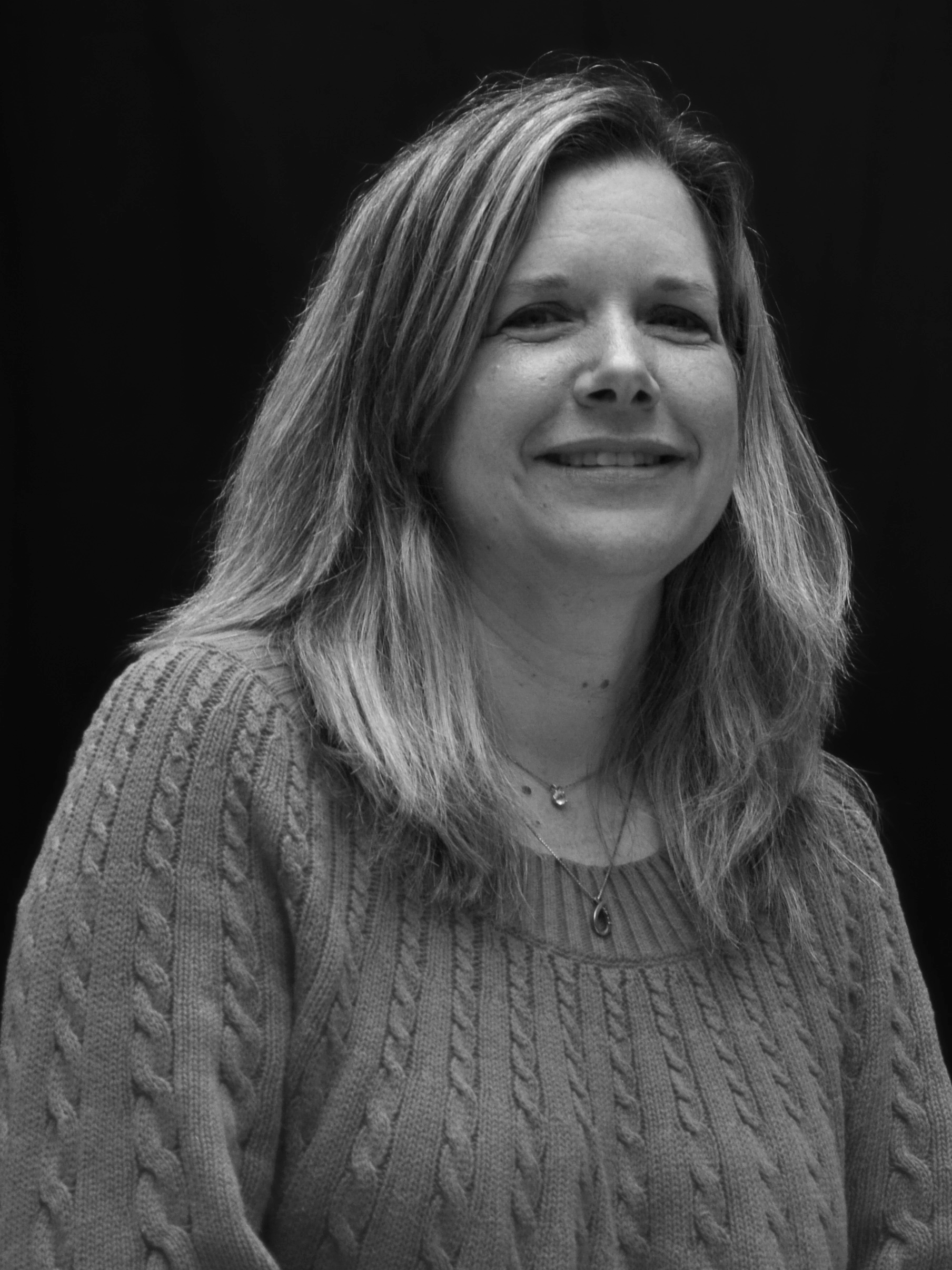 A black and white image of actor Kathryn Bell from the shoulders up