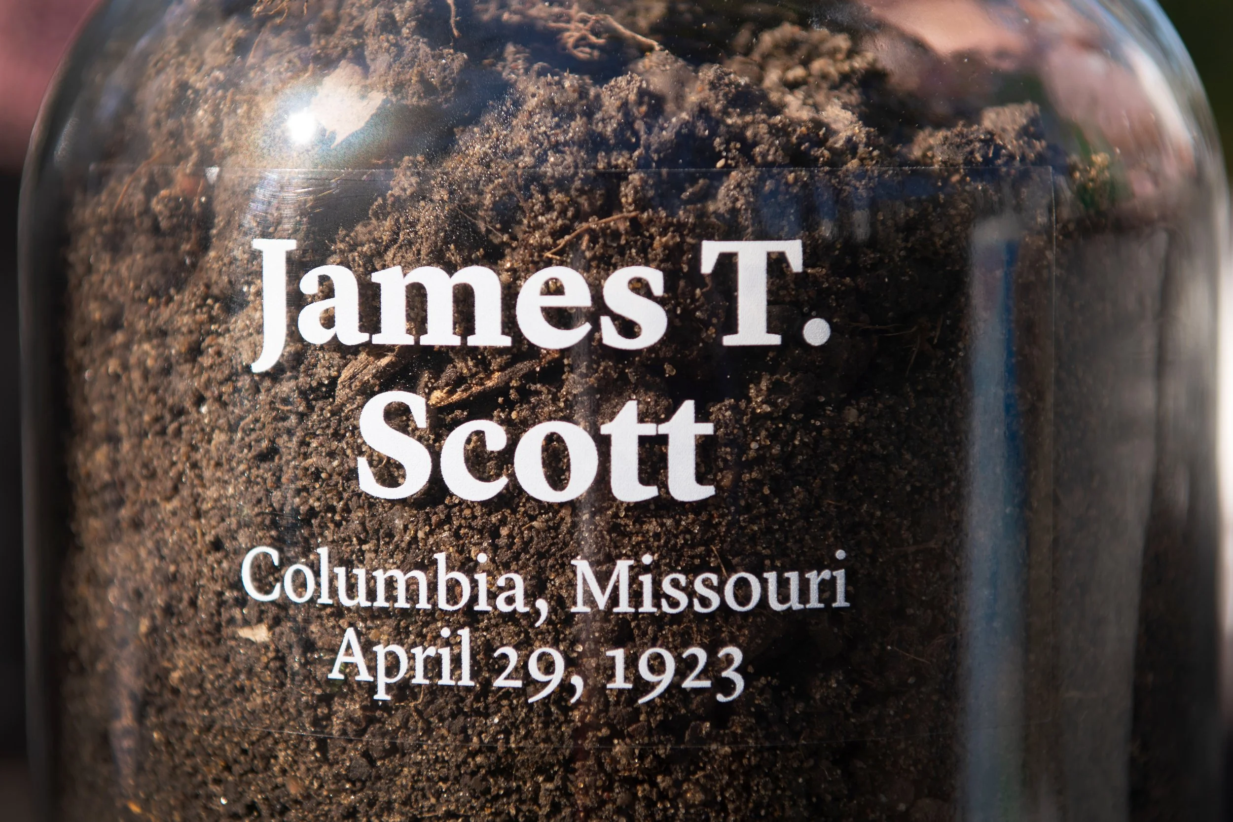 Jar of soil from the lynching site of James Scott with label reading "James T. Scott, Columbia, Missouri, April 29, 1923.