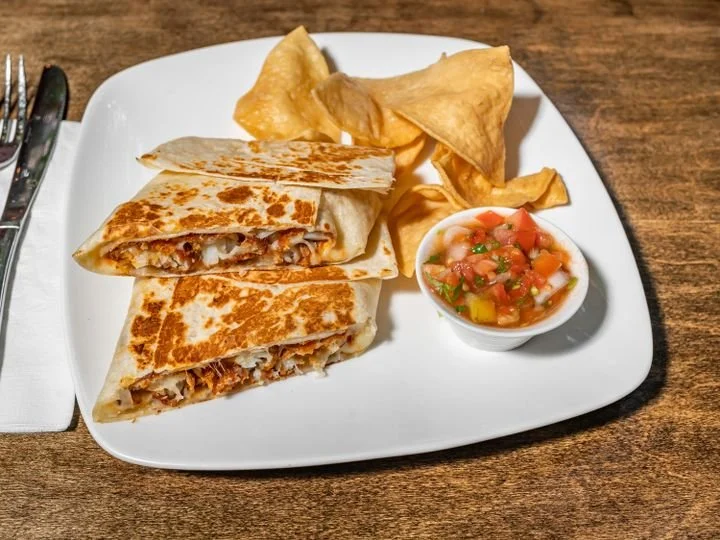 Plate with quesadilla, potato chips, and salsa